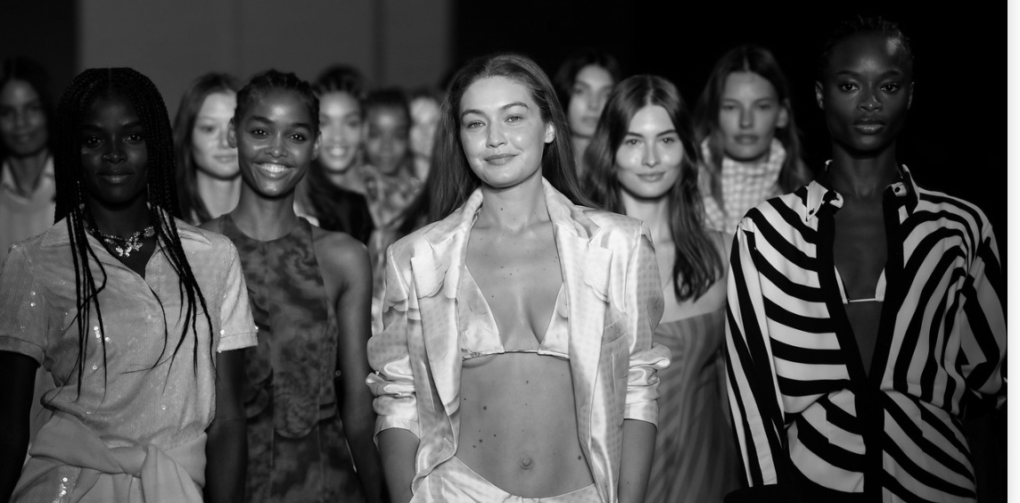 Models backstage at New York Fashion Week, photographed in black and white