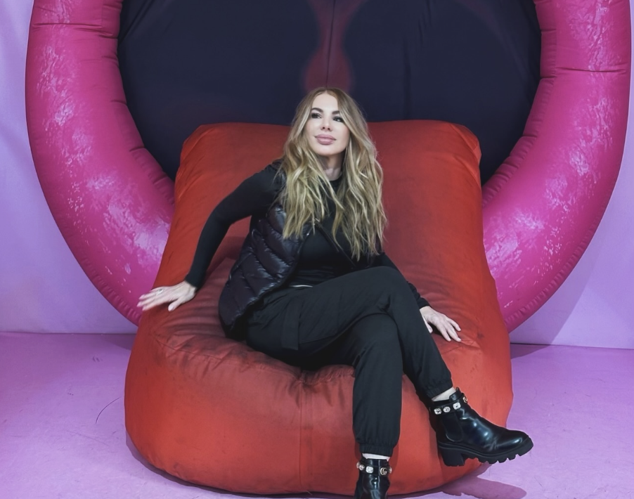 Ula DiGiovanni seated in a sculptural lip chair