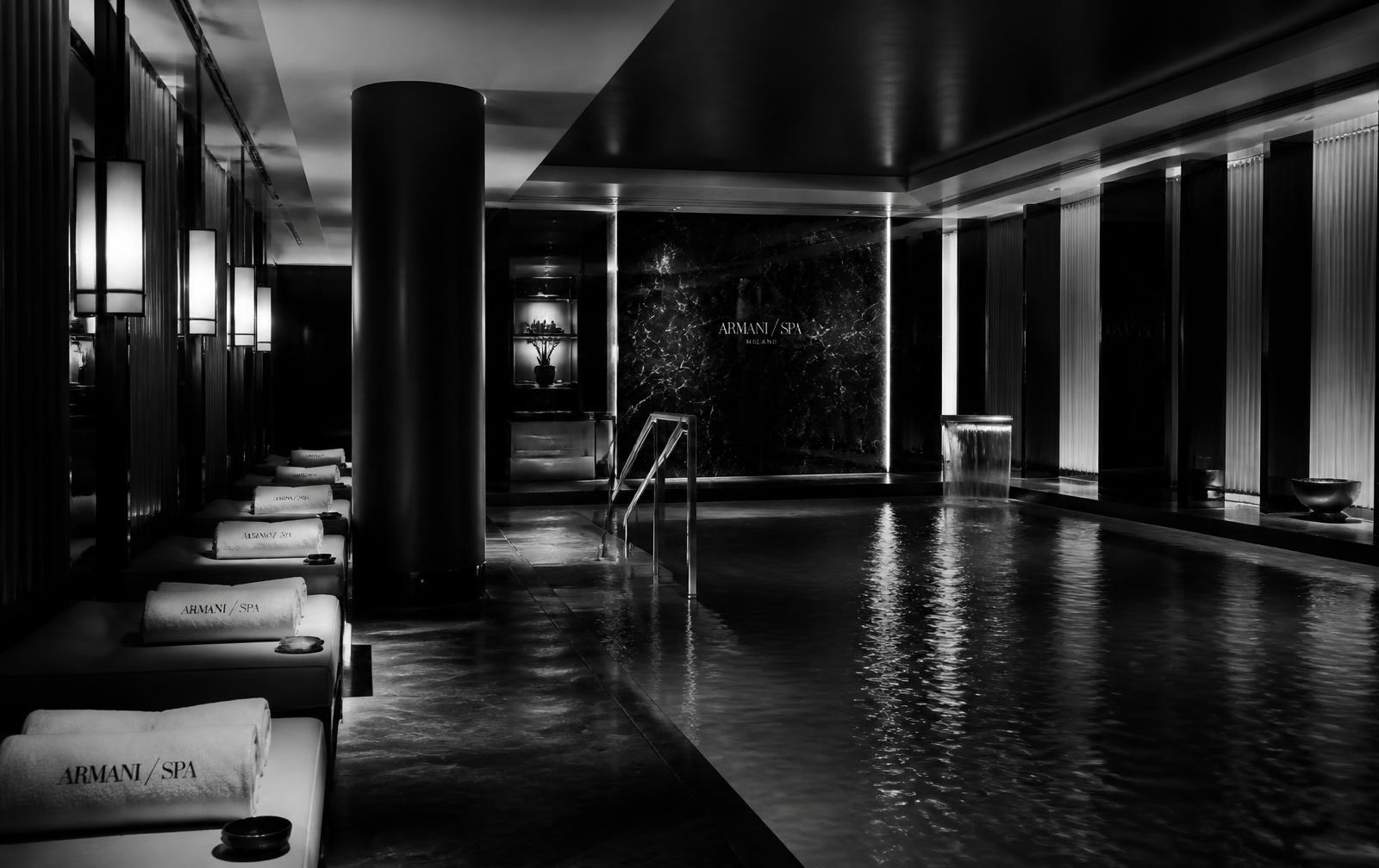 Black-and-white photograph of the Bvlgari Hotel Milano spa, a dark marble vitality pool in Brera