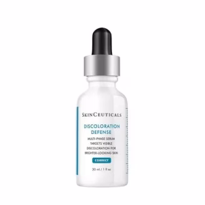 A 30ml white bottle of Skinceuticals Discoloration Defense serum with a black dropper cap and blue and black text, formulated to target visible discoloration and promote brighter-looking skin.