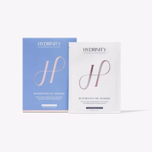 A blue box and a white sachet of Hydrinity restorative HA mask 5pack, both with a large pink H and minimalist design, are shown against a plain white background.