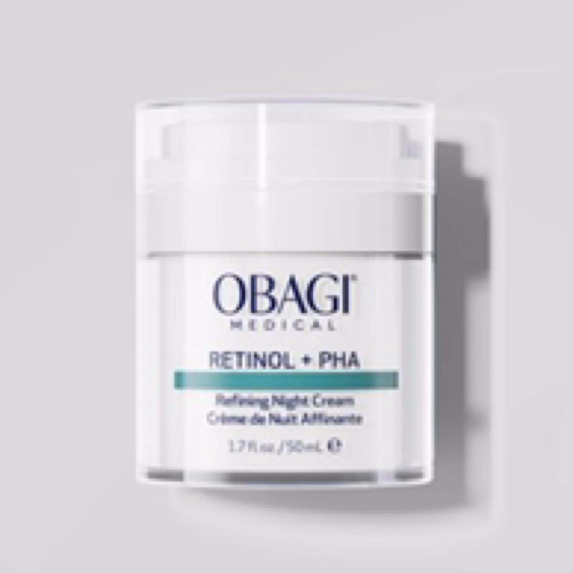 A jar of Obagi Medical Retinol + PHA Refining Night Cream, featuring a white and silver design with blue and black text on the label, is displayed against a light gray background.