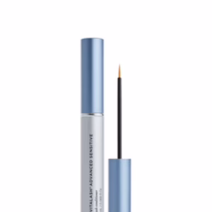 A tube of Revitalash Lash Serum - Sensitive with a metallic blue cap is shown open, revealing the thin applicator brush standing upright beside the tube.