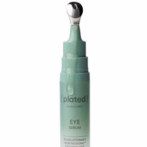 A green tube of Plated Eye Serum with a silver applicator tip, standing upright against a white background.