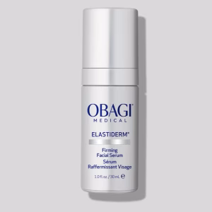 A white bottle of Obagi ELASTIderm Facial Serum with a pump dispenser sits against a light gray background, featuring product details in English and French on the label.
