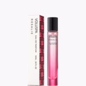 A pink gradient Voluspa Rosalie Perfume bottle sits beside its matching white and pink box, both featuring the brand name and Eau de Parfum labeling.