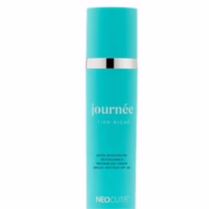 A turquoise bottle of Neocutis Journee Firm moisturizer features silver accents and white text on its label.